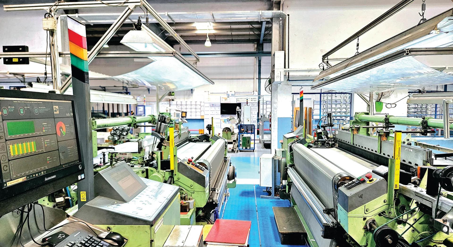 Weaving floor with looms and the MES control station at BVK in Jaipur
